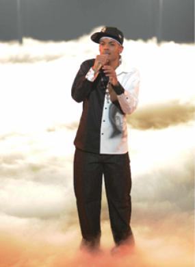 Color image of Jero performing on stage filled with smoke